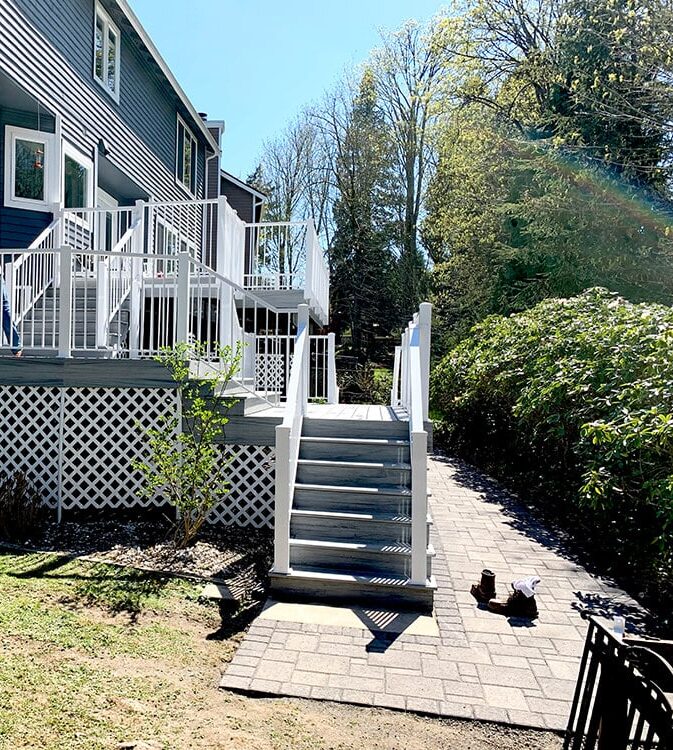 a house with a white railing and stairs