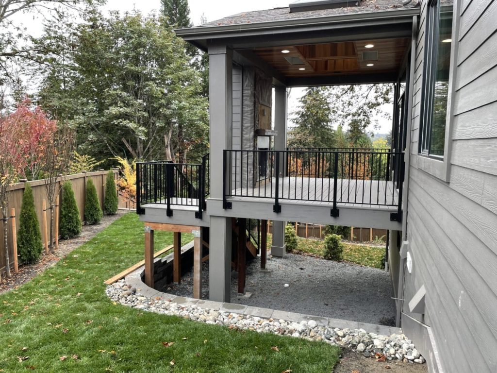 Img_8141 a deck with a black railing and a green lawn