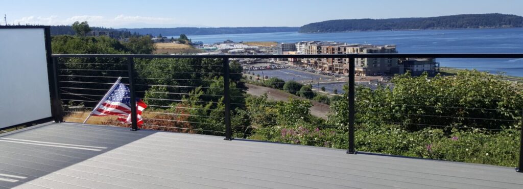 a deck with a railing overlooking a city