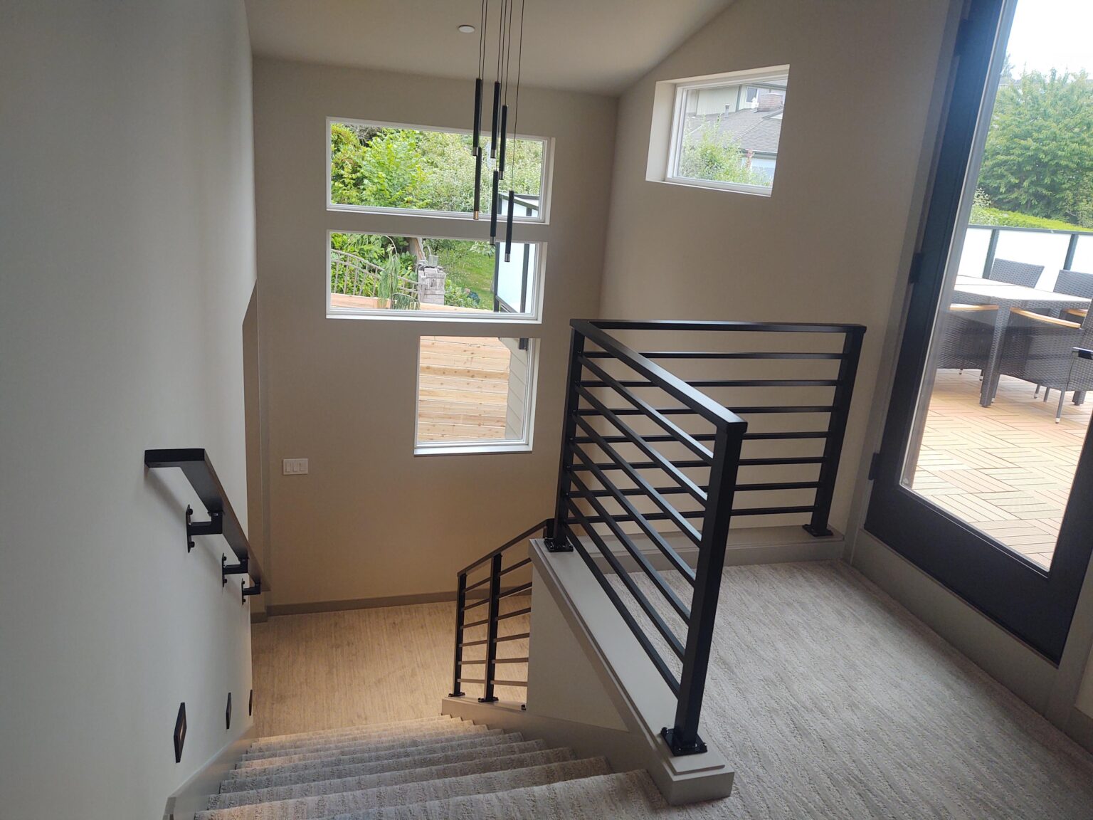 Everett residence with black horizontal deck and stair railings