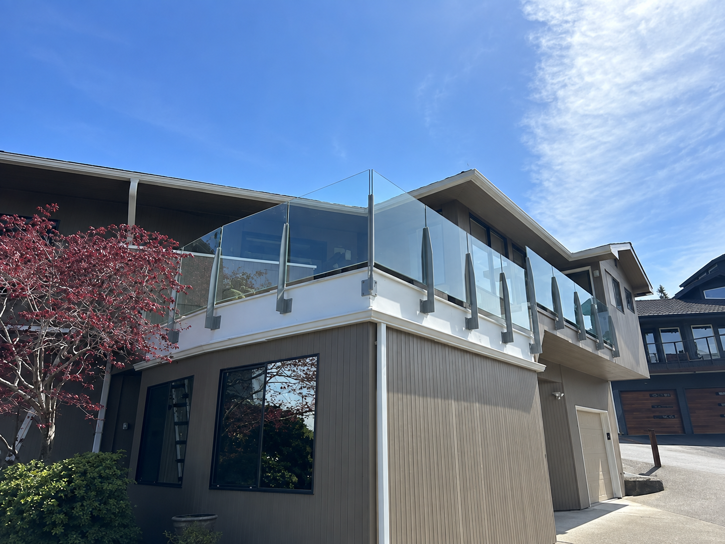 Mukilteo home exterior with infinity glass deck railing