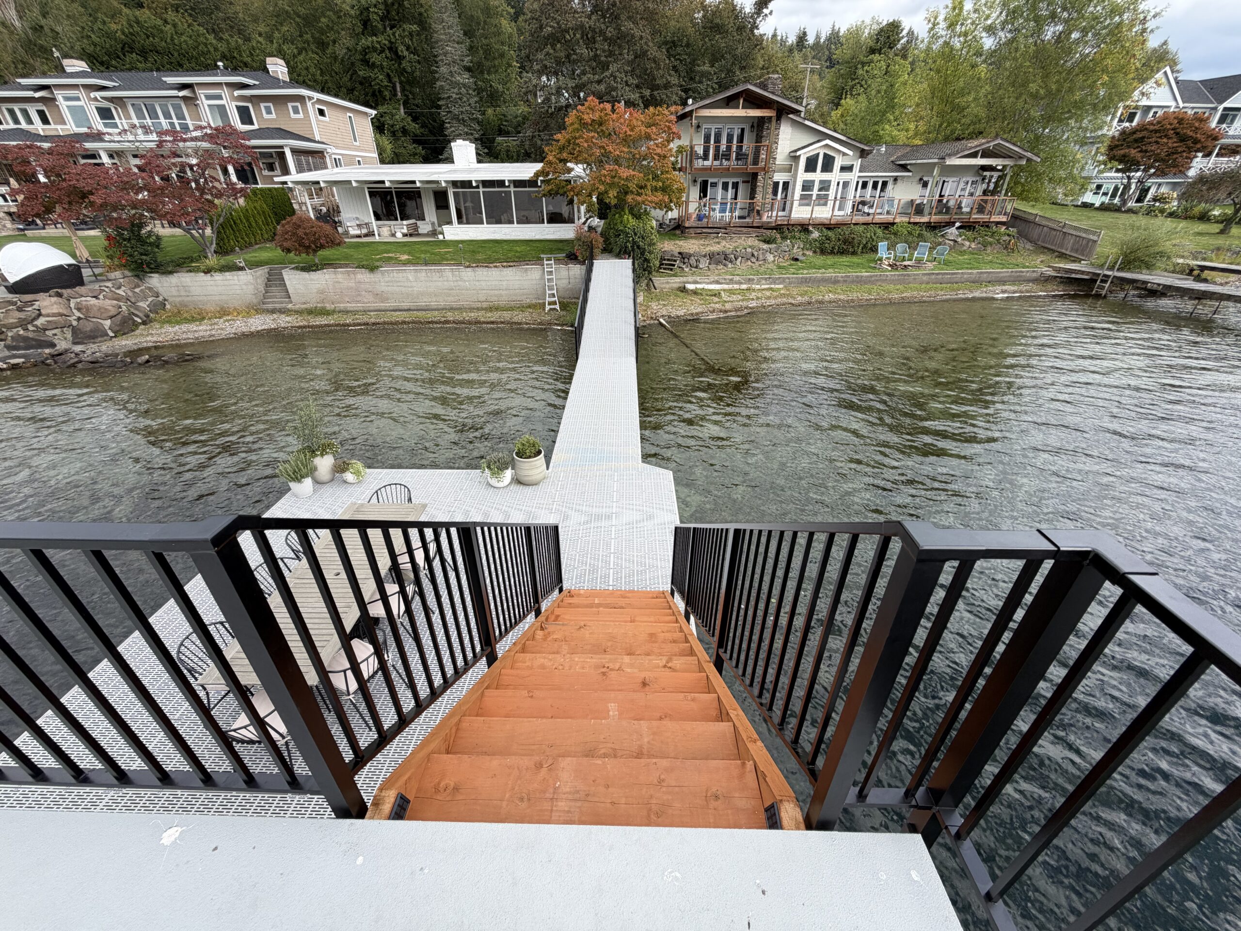 Picket railings and rectangular top rails at the dock stair landing